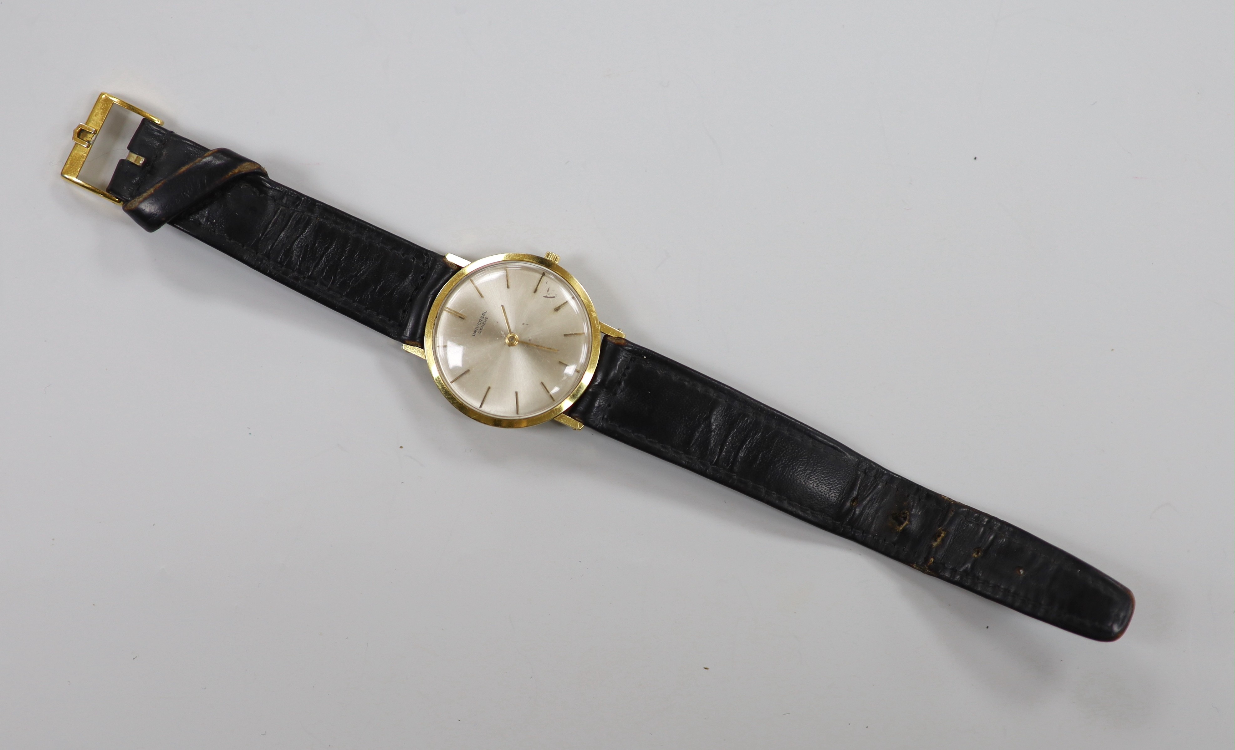 A gentleman's 18ct gold Universal manual wind wrist watch, with baton numerals, on a leather strap with gold plated Universal buckle, gross weight 28.1 grams.